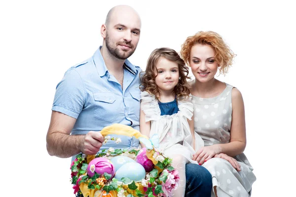 Parents and daughter holding basket with Easter eggs Stock Picture