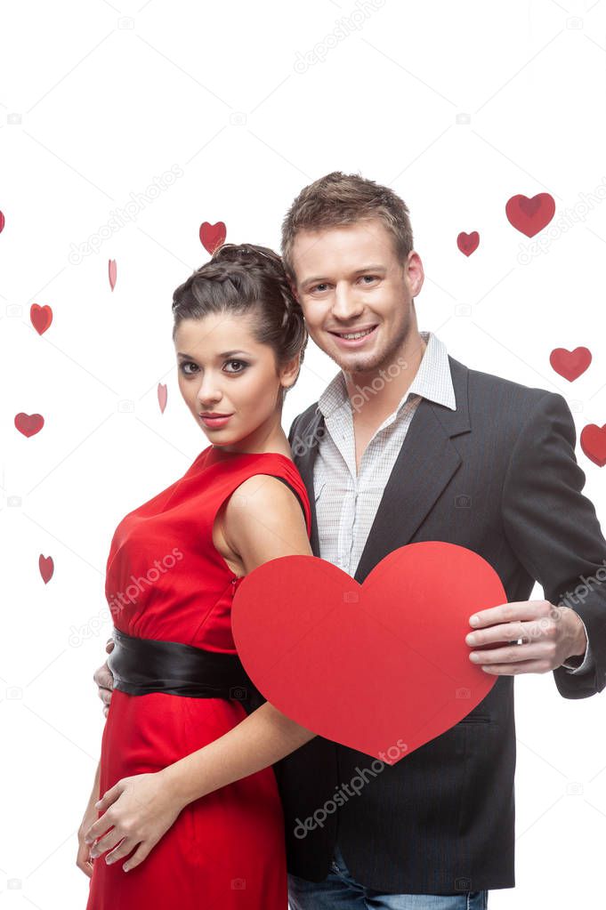 Attractive and well-dressed couple posing in studio. 