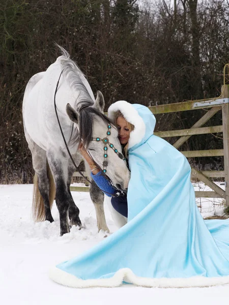 雪の中の女と馬 — ストック写真