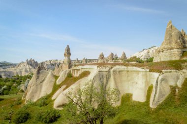 scenic view of stone formations on slopes in valley of Cappadocia, Turkey clipart