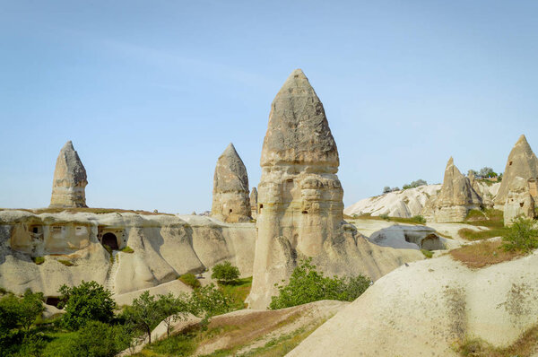 front view of old cave dwelling and fairy chimneys in valley of Cappadocia, Turkey