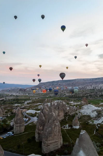 Front view of hot air balloons flying over stone formations, Cappadocia, Turkey — Stock Photo