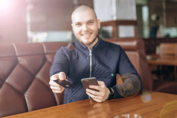 man enters credit card information into the phone