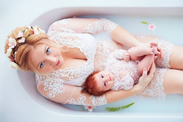 Young Happy Mother Newborn Baby Girl Daughter Floral Milk Bath — Zdjęcie stockowe