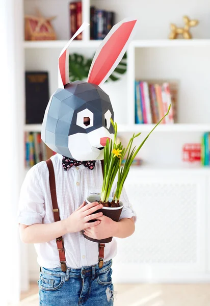 portrait of stylish polygonal easter rabbit with a fresh spring potted flowers, polygonal mask