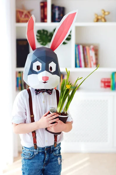 portrait of stylish polygonal easter rabbit with a fresh spring potted flowers, polygonal mask