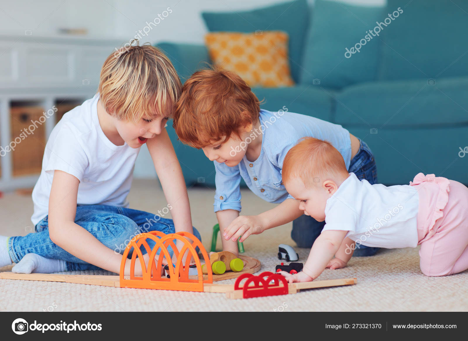 Cute kids, siblings playing toys together on the carpet at home Stock