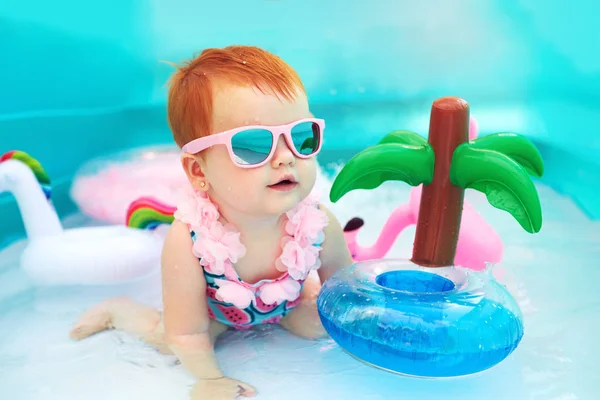 Cute happy baby girl having fun in kid pool, summer vacation Royalty Free Stock Images