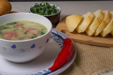 Caldo Verde Çorbası, Portekiz mutfağında yeşil sebzeli ve üzerine dilimlenmiş seramik kase ve bir parça ekmek ve biberli popüler bir çorbadır. Üst Görünüm