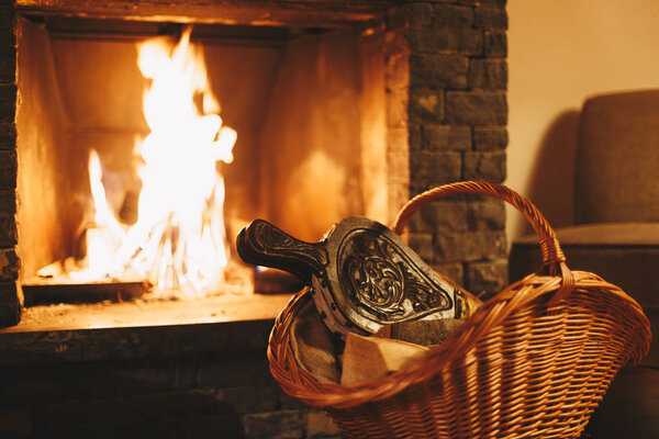 Корзина с дровами на полу в деревенском доме
