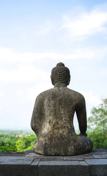 Statue of sitting buddha at Borobudur Temple, spiritual stone sculpture, UNESCO world heritage site