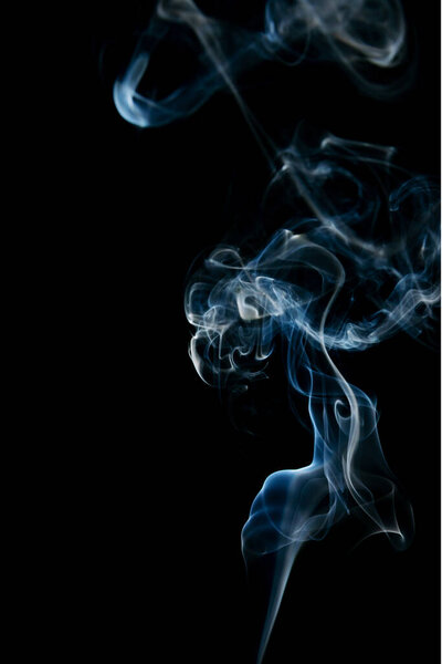 Natural smoke on a solid black background. Beautiful twists