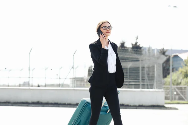 Business woman at international airport moving to terminal gate for airplane travel trip - Mobility concept and aerospace industry flight connections