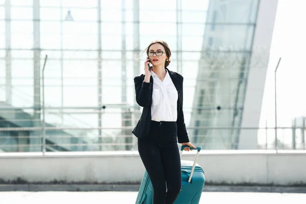 Business woman at international airport moving to terminal gate for airplane travel trip - Mobility concept and aerospace industry flight connections