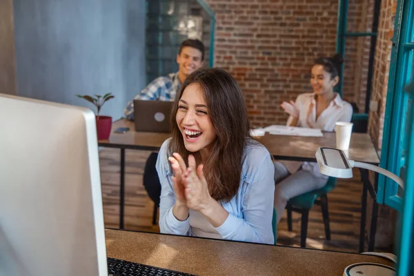 young woman celebrate success at work pointing on his laptop. startup