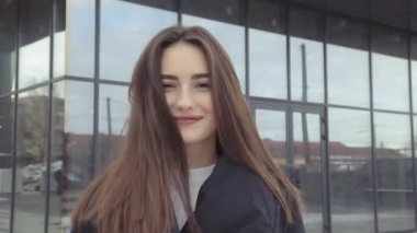 Genç kız gülümseyerek kameraya poz, şehir içinde fotoğraflandı gülüyor. Hdslow hareket