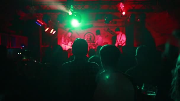 Concert Crowd Attending Concert People Silhouettes Visible Backlit Stage Lights — Stock Video