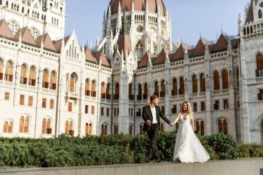 Gelin ve damat kente sokak sarılma. Evlilik çift aşık. Lüks yapay elmas elbise. Sıcak yaz günlerinde.