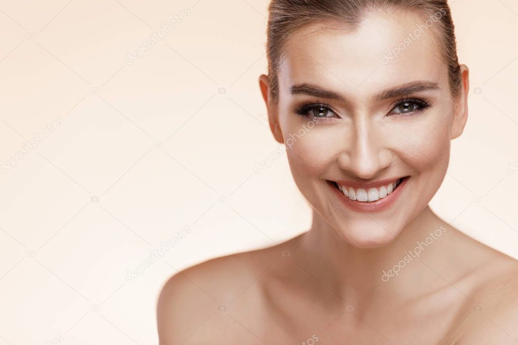 Beautiful Young Smiled Girl With Perfect Skin On Beige Background. Skin Care Concept 