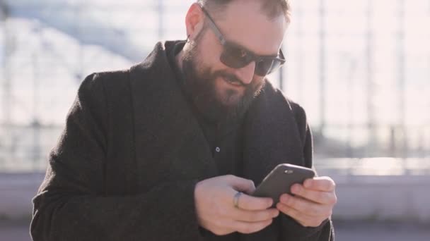エアポートを歩いて 携帯電話を使うビジネスマン — ストック動画