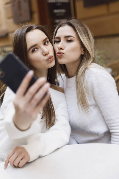 Girlfriends have fun in cafe