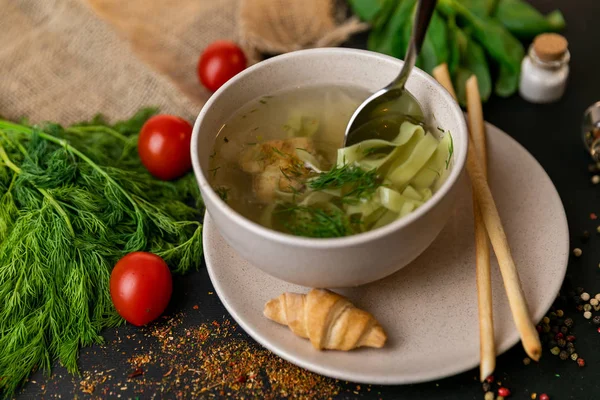 Chicken and potato chowder soup with green bell pepper and carrot in bowls. Healthy food, top view. Black background . Slow-m