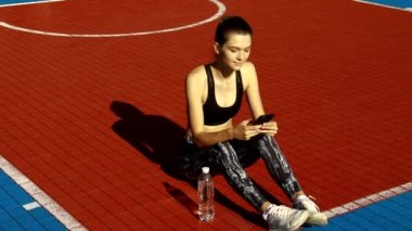 Kadın açık havada çalıştırdıktan sonra yorgun hissediyorum. Üzgün yorgun hayal kırıklığına kadın atlet spor spor müsabakasını, yaralı bacak ağrı hissi kaybettikten sonra yere oturuyor içinde. Yüksek çözünürlük.