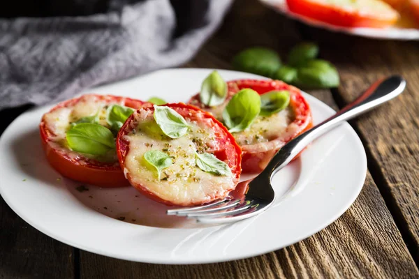 stock image Tomatoes baked under Parmesan with fresh basil