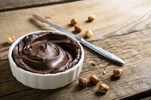 Chocolate and nut paste on wooden table