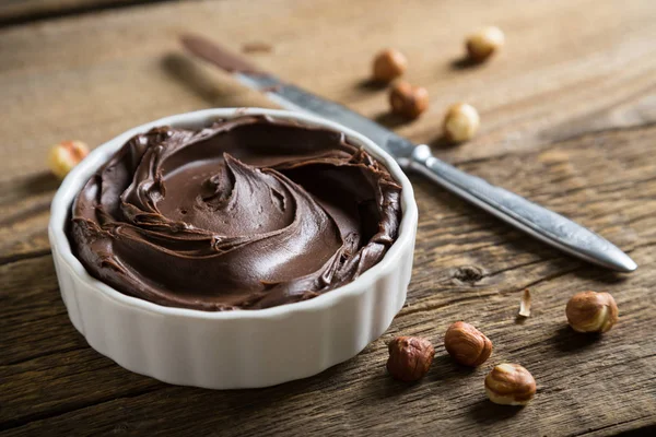 Chocolate and nut paste on wooden table