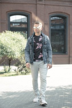 Young man posing on a city street