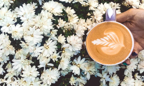 A cup of coffee in his hand. Summer coffee. Cappuccino.