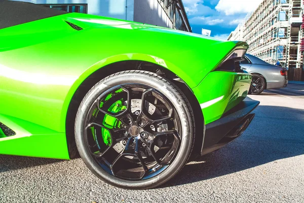 Green sports car. Sports car. Wheels and tires of the car.