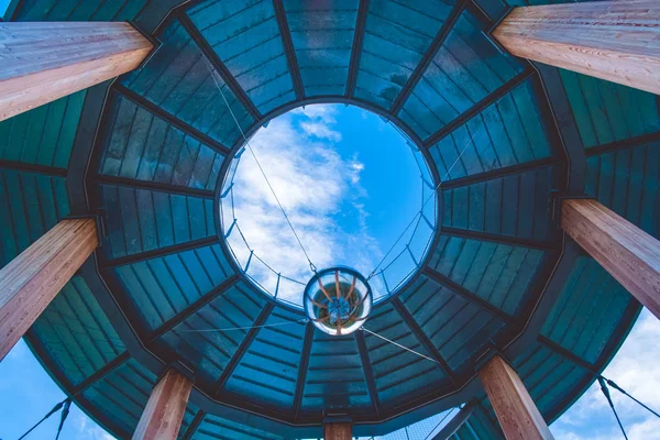 Observation deck. Spiral staircase. Modern architecture. Metal ball on the ropes. Mirror ball. Autumn forest. Beautiful view. Height. The mountains. Germany. Journey. Ball for balance Wooden beams. Metal cables. Tower.