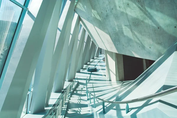 Modern architecture. Lines in construction. White interior. Design solution. Big windows. Glass. Beams. Grid of ropes. Stairs. The museum.