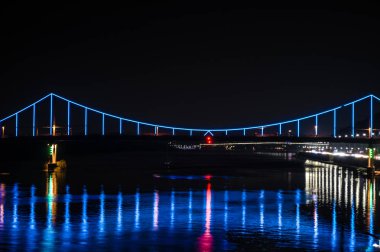 Mavi ve kırmızı ışıklar ve yansıma su, Ukrayna (Kiev) başkenti Kiev gece Avrupa şehirde. Dnieper Nehri ve görünümü aydınlatma akşam nehir İstasyonu yaya köprüsü