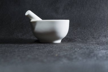 Beyaz harç havaneli Porselen takımlar ile. Baharatlar kırma için içme bir kase. Siyah arka plan. Mutfak eşyaları. Tesisat.