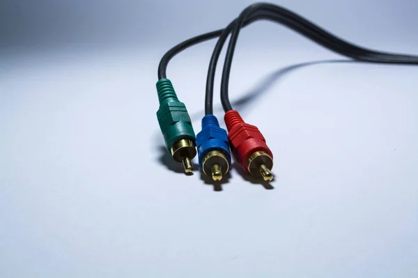 Multimedia multi-colored cables. Or tulips adapters for audiodevices. On a white background. The isolated object. Black cord.