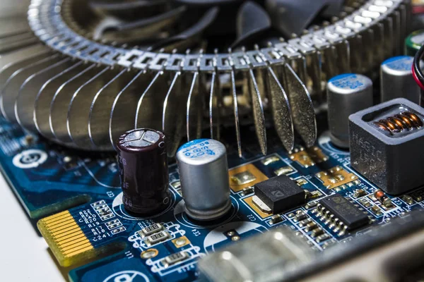 Old cooler from the computer. Motherboard of blue color. Repair of the personal computer. Modern technologies. Workshop. — Stock Photo, Image