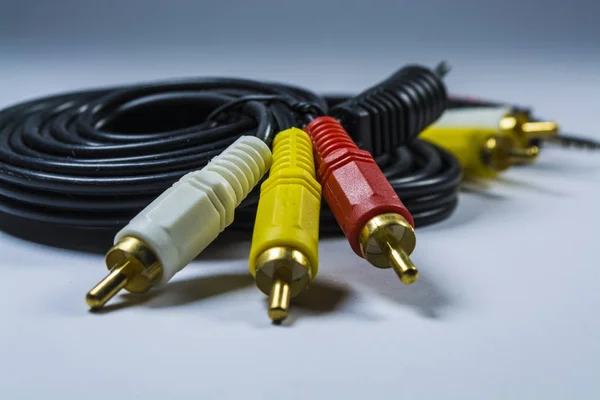 Two hanks of cables with multi-colored plugs a tulip. Black cord. White monophonic background. — Stock Photo, Image
