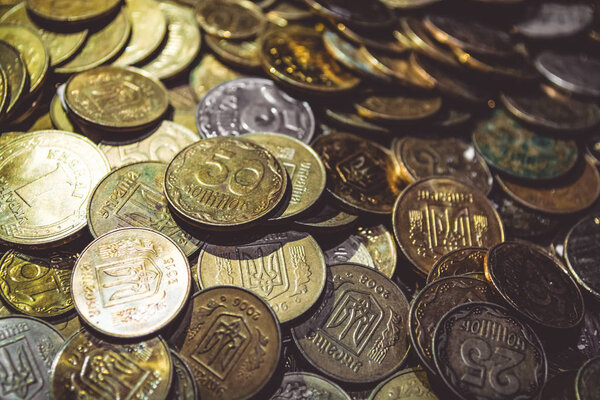 A lot of gold coins. Finance, business, money. Hryvnia. Profit. Currency. Texture and background.