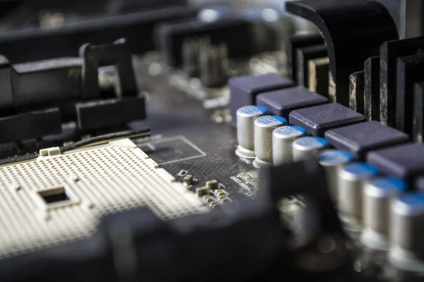 The blue motherboard and details, old and with dust from the personal computer. Repair. Texture or background. Workshop.