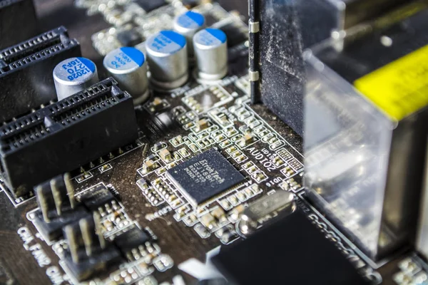 The blue motherboard and details, old and with dust from the personal computer. Repair. Texture or background. Workshop.