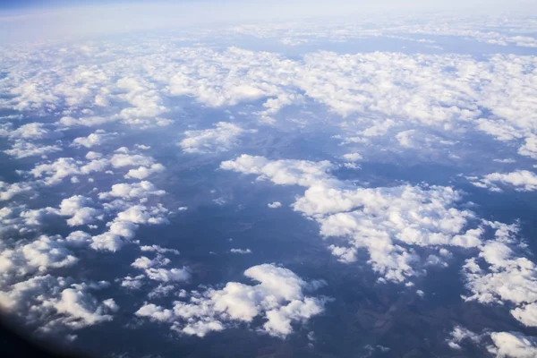 从平面窗口可以看到云和蓝色晴朗的天空, 从高处看地球。从山的空气美丽的看法. — 图库照片