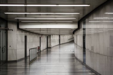 Beyaz-gri Oda. Uzun bir koridor aydınlatma. Işık duvarlar ve zemin. Parlaklık. Arka plan.