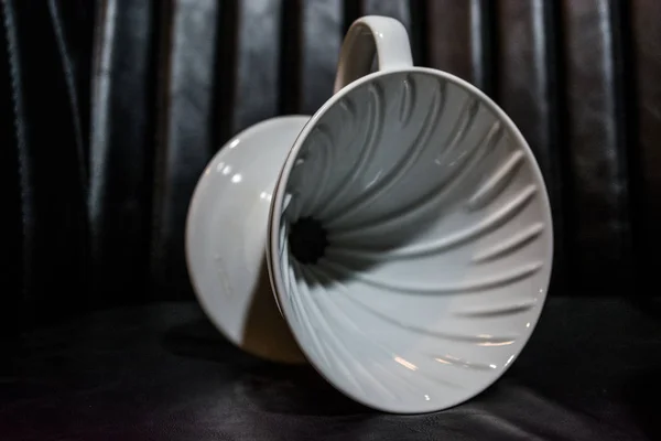 White funnel Pourover on black background for preparation of coffee by alternative method. Work barista in coffee shop. Caffeine — Stock Photo, Image