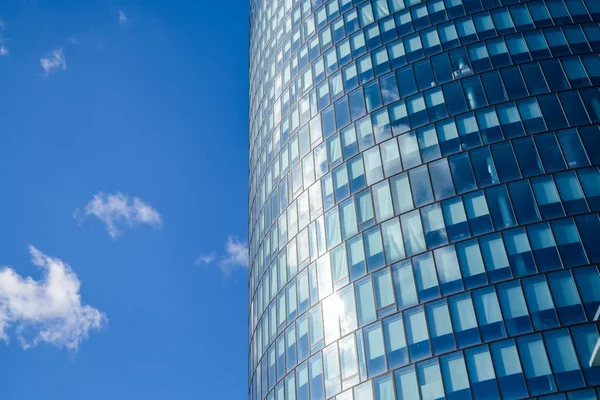 Arquitectura moderna de edificios de oficinas. Un rascacielos de cristal y metal. Reflejos en ventanas de cielo azul. Centro de negocios . — Foto de Stock