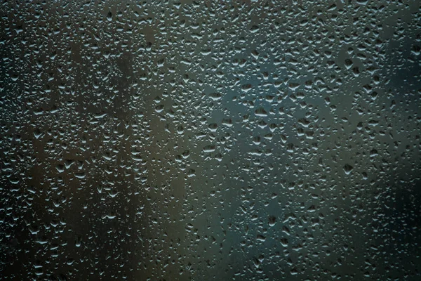 Background or texture. It is a lot of small a rain drops on window glass. Rainy day of spring. — Stock Photo, Image