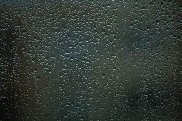 Background or texture. It is a lot of small a rain drops on window glass. Rainy day of spring. — Stock Photo, Image