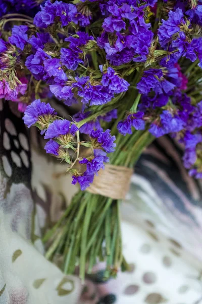 Bouquet of field and arid flowers on cloth with leopard and zebra print.